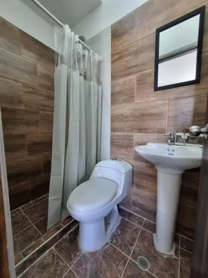 a bathroom with a toilet and a sink at MONTEMAR Casa 2 in Santiago