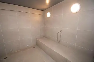 a bathroom with a tub and two lights on the wall at U-GO Morros EOS Lujo Frente al Mar en Serena del Mar in Cartagena de Indias