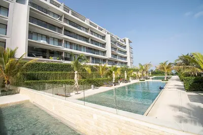 a swimming pool in front of a large building at U-GO Morros EOS Lujo Frente al Mar en Serena del Mar in Cartagena de Indias