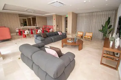 a living room with two couches and a table at U-GO Morros EOS Lujo Frente al Mar en Serena del Mar in Cartagena de Indias