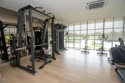 a gym with a row of tread machines in a room at U-GO Morros EOS Lujo Frente al Mar en Serena del Mar in Cartagena de Indias