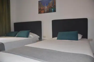 two beds sitting next to each other in a room at Hotel San Rafael in Sincelejo