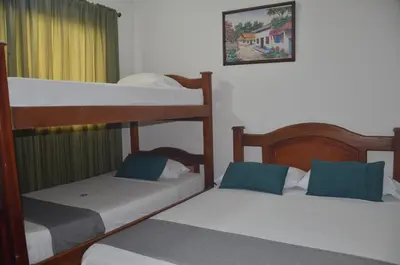 a bedroom with two bunk beds and a picture on the wall at Hotel San Rafael in Sincelejo