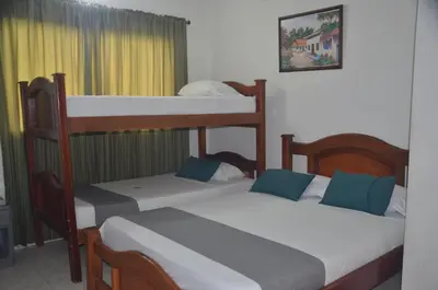 a bedroom with two bunk beds with blue pillows at Hotel San Rafael in Sincelejo