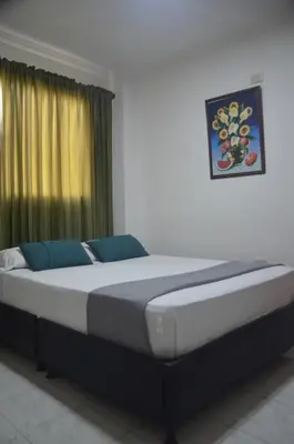 a large bed in a room with a window at Hotel San Rafael in Sincelejo