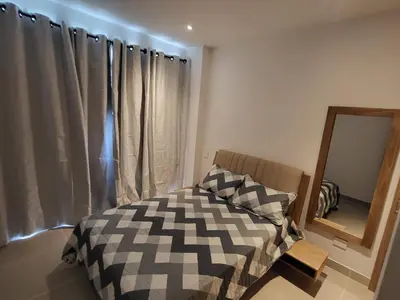 a bedroom with a bed and a mirror at Apartamento lujoso y moderno in Cartagena de Indias