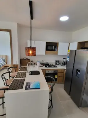 a kitchen with a counter top and a refrigerator at Apartamento lujoso y moderno in Cartagena de Indias