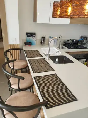 a kitchen with a sink and two chairs at Apartamento lujoso y moderno in Cartagena de Indias