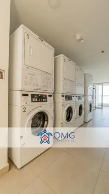 a row of washing machines in a laundry room at CB1242 | Estudio moderno con diseño natural y piscina in Cartagena de Indias