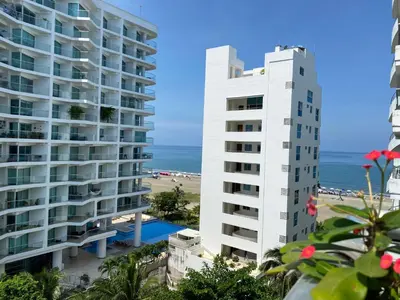 a view of two tall buildings and the beach at Apartment with direct access to the Sea in CTG in Cartagena de Indias