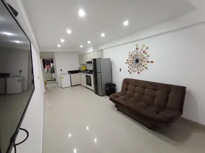 a living room with a couch and a kitchen at Apto Marbella in Cartagena de Indias