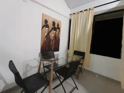 a dining room with a glass table and chairs at Apto Marbella in Cartagena de Indias