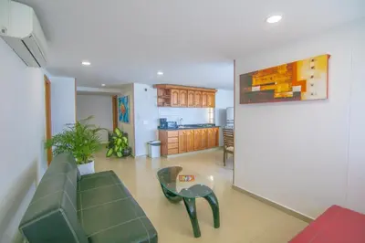 a living room with a couch and a table at 2C-AL2E APARTAMENTO DE 2 ALCOCABAS CERCA AL MAR CON AIRE ACONDICIONADO, PISCINA Y WIFi in Cartagena de Indias