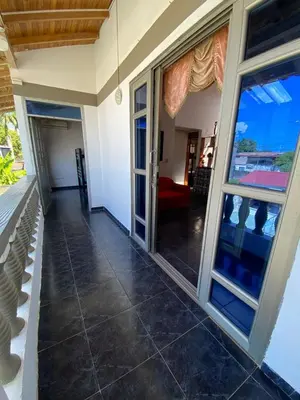 a large glass door on a house with a porch at Cabaña Tolu in Santiago