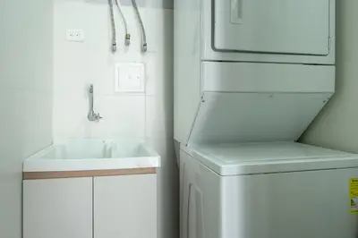 a white kitchen with a sink and a refrigerator at Luxury Oceanfront Apartment in Cartagena Centro in Cartagena de Indias