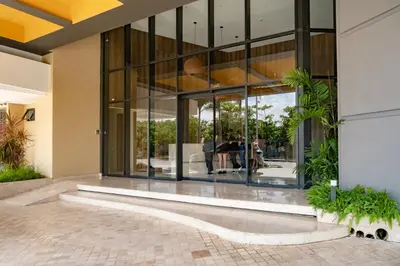a large glass building with people in it at Luxury Oceanfront Apartment in Cartagena Centro in Cartagena de Indias