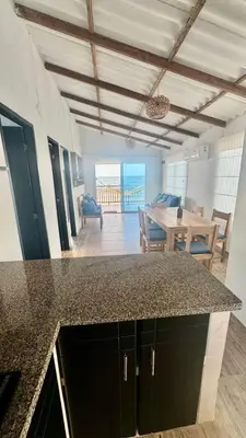 a kitchen and dining room with a view of the ocean at Hermosa Cabaña Frente Al Mar in San Bernardo del Viento