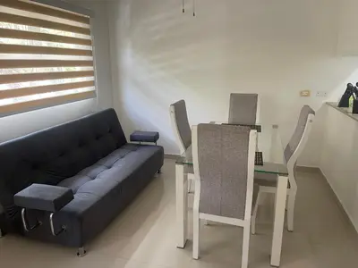 a living room with a couch and a table at Italia boutique Apt 2 in Barranquilla