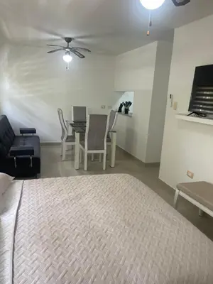 a bedroom with a bed and a table and chairs at Italia boutique Apt 2 in Barranquilla