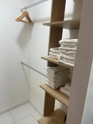 a pile of towels on a shelf in a bathroom at Italia boutique Apt 2 in Barranquilla