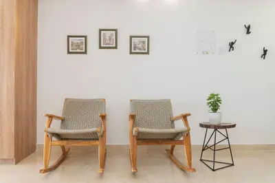two chairs sitting next to a wall with a table at CB906 | Encantadora suite ocean view y diseño cálido in Cartagena de Indias
