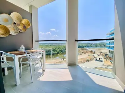 a dining room with a table and a large window at Morros EOS Manzanillo piso 3 in Cartagena de Indias