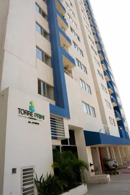 a tall building with a corner firm sign on it at Vista panoramica al Mar y Piscina in Cartagena de Indias