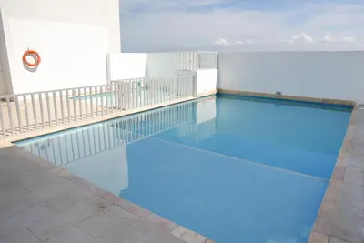 a swimming pool with blue water in a building at Vista panoramica al Mar y Piscina in Cartagena de Indias