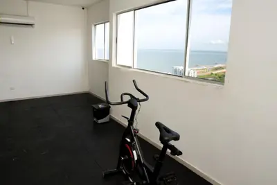 a bike parked in a room with a window at Vista panoramica al Mar y Piscina in Cartagena de Indias