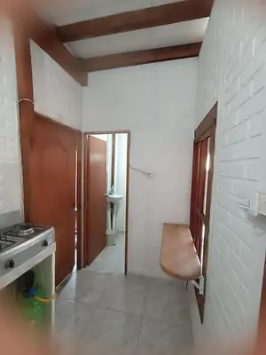 a kitchen with a sink and a stove in a room at Hostal Playa Descalzo in Cartagena de Indias