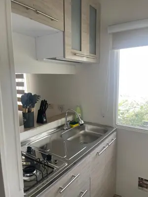 a kitchen with a sink and a stove and a window at Italia boutique #3 in Barranquilla