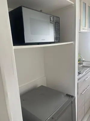 a microwave oven sitting on top of a refrigerator at Italia boutique #3 in Barranquilla