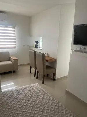 a living room with a table and chairs and a couch at Italia boutique #3 in Barranquilla