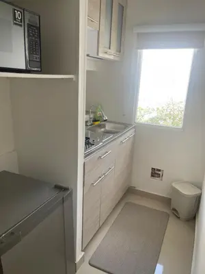 a small kitchen with a sink and a window at Italia boutique #3 in Barranquilla