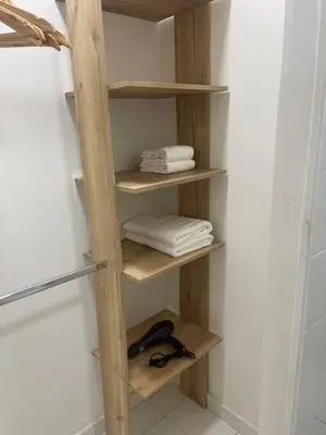 a wooden shelf in a bathroom with towels at Italia boutique #3 in Barranquilla