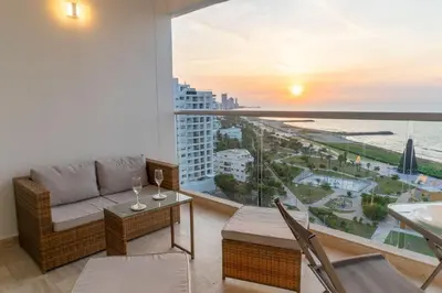 a living room with a couch and a view of the ocean at Oceanfront studio + sunset views CB1403 in Cartagena de Indias