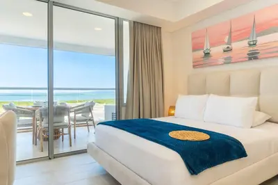 a bedroom with a bed and a view of the ocean at CB1631 | Piso 16 con balcón y vista panorámica in Cartagena de Indias