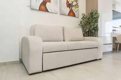 a white couch sitting in a living room at CB1631 | Piso 16 con balcón y vista panorámica in Cartagena de Indias