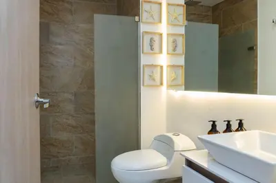 a bathroom with a toilet and a sink and a mirror at CB1631 | Piso 16 con balcón y vista panorámica in Cartagena de Indias