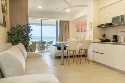 a living room with a couch and a table with chairs at CB1631 | Piso 16 con balcón y vista panorámica in Cartagena de Indias