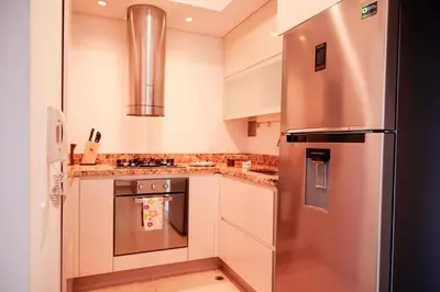 a kitchen with a large stainless steel refrigerator at Dizztravel Apart H2 - 1602 Exclusivo Bocagrande in Cartagena de Indias
