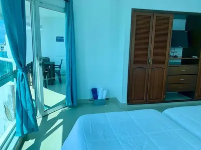a bedroom with a bed and a sliding glass door at Tu Pent-House Con Vista al Mar! in Cartagena de Indias