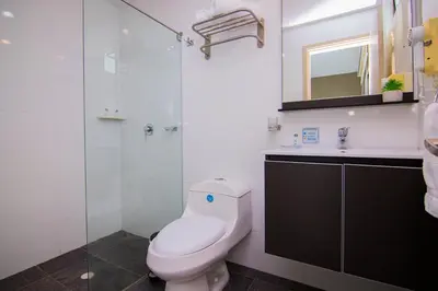 a bathroom with a toilet and a sink and a shower at Varanasi Hotel Boutique Aeropuerto in Cartagena de Indias