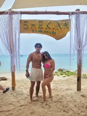 a man and a woman standing on the beach at Shekina Club House in Playa Blanca