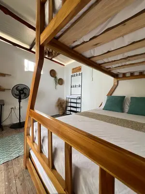 a bedroom with a large bed with wooden beams at Shekina Club House in Playa Blanca