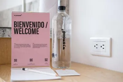 a bottle of water sitting on a table next to a box at San Martin by Wynwood House in Cartagena de Indias