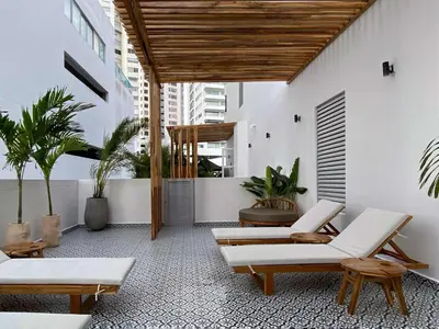 a patio with a bunch of chairs and plants at San Martin by Wynwood House in Cartagena de Indias