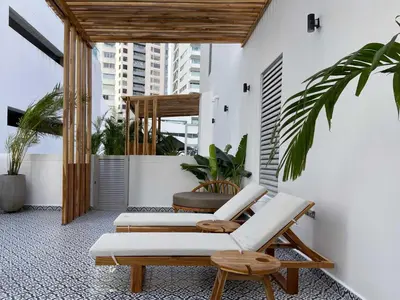 a patio with two lounge chairs and a table at San Martin by Wynwood House in Cartagena de Indias