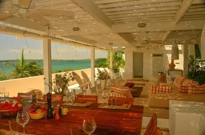 a living room with a view of the ocean at Villa Los Cocos Baru in Baru