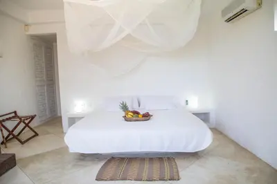 a bedroom with a bed with a bowl of fruit on it at Villa Los Cocos Baru in Baru
